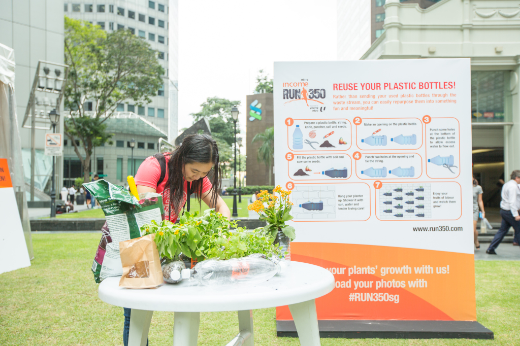 In the process of planting seeds into a plastic bottle. (Credit: RUN350).