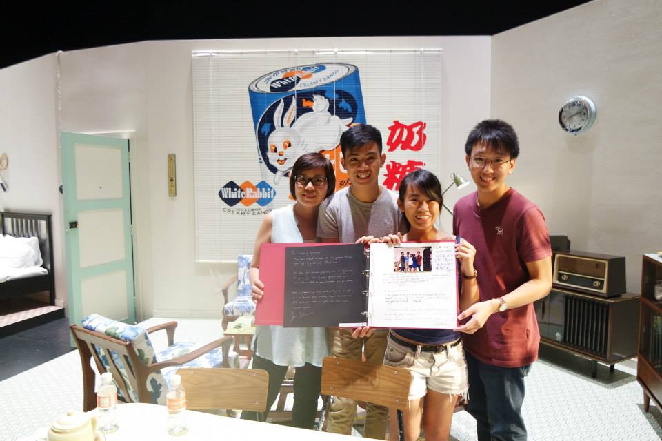 Zhi Wen (2nd from right) and her family holding up the guestbook at the Esplanade.