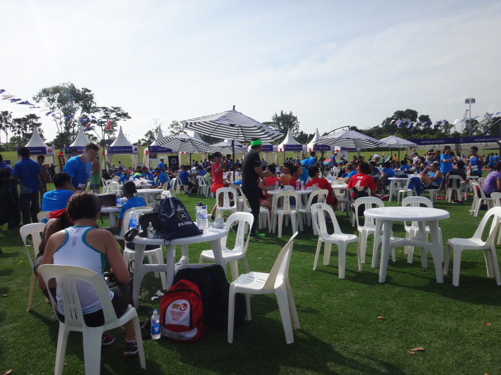 Runners lounging around on chairs at the race village.