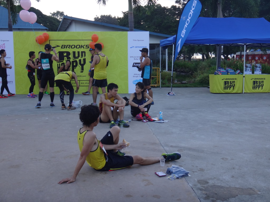A runner sits on the floor and reflects how his race went.