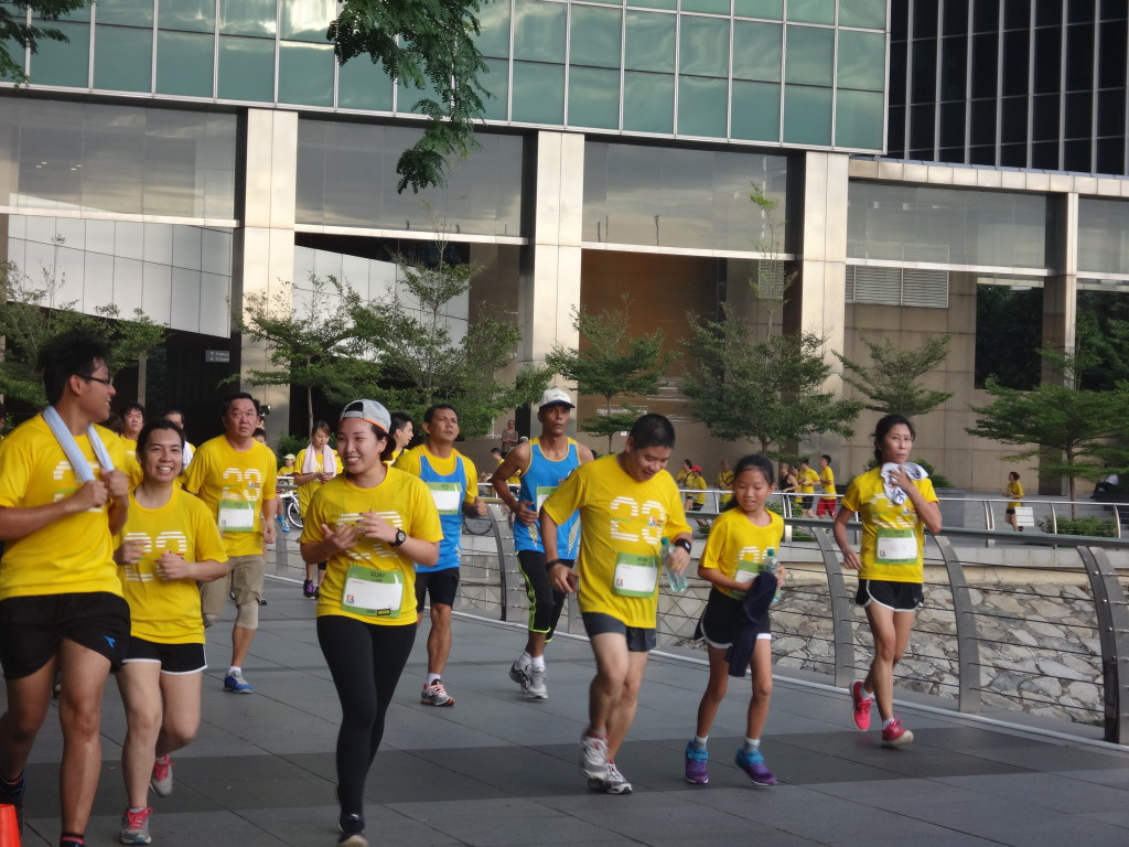 Runners head past the NTUC Building in Raffles Place.