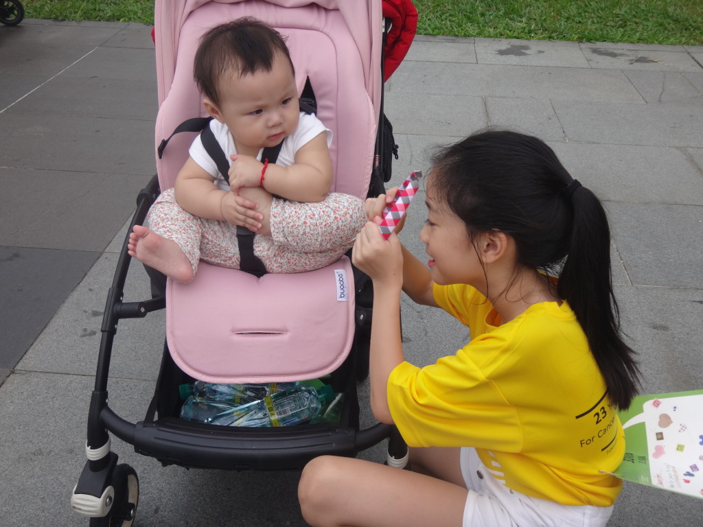 A young girl shares some bonding time with her baby sibling.