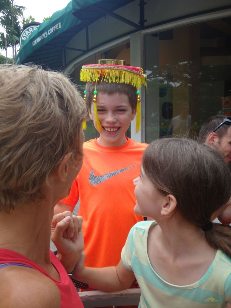 The little boy gets into the Chinese New Year mood, while his mum and sister look on.
