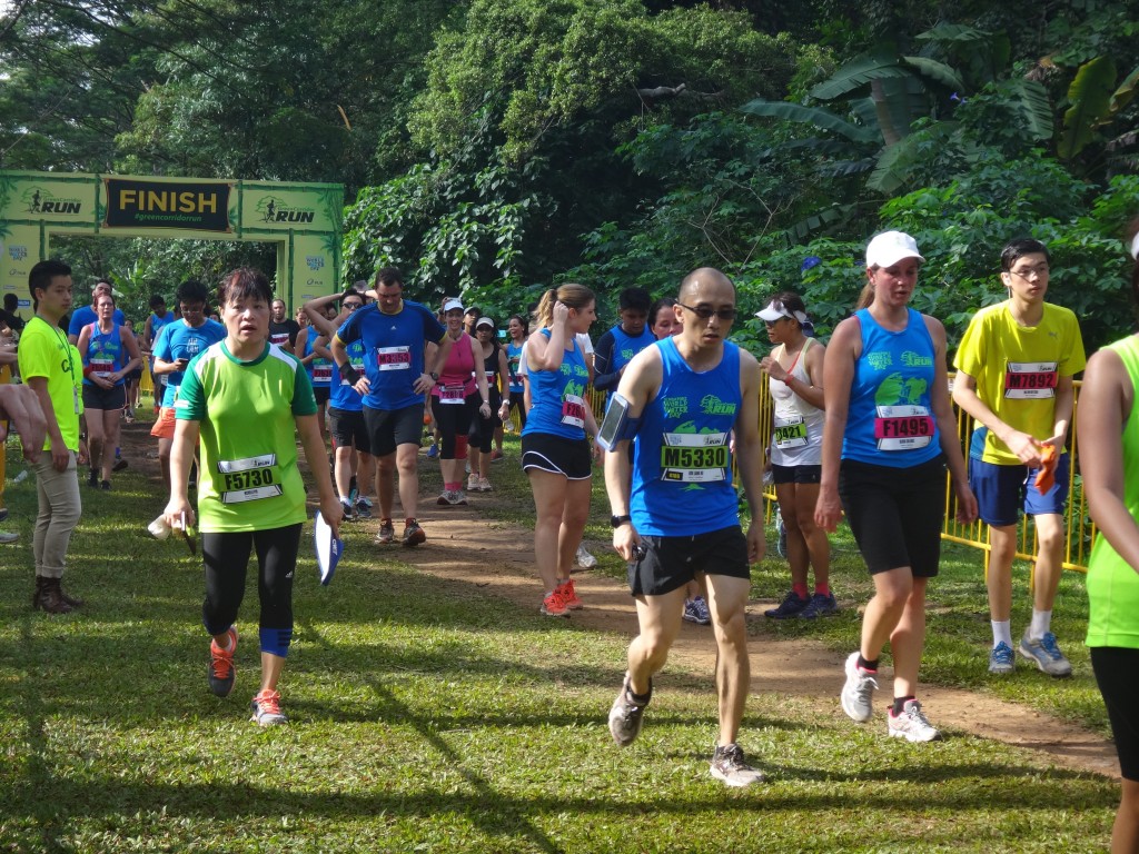 Exhausted runners cross the finishing line.