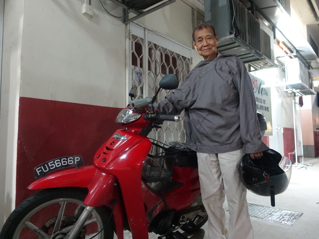 Chan, photographed here with his motorbike, was pleased with how his 101st marathon went.