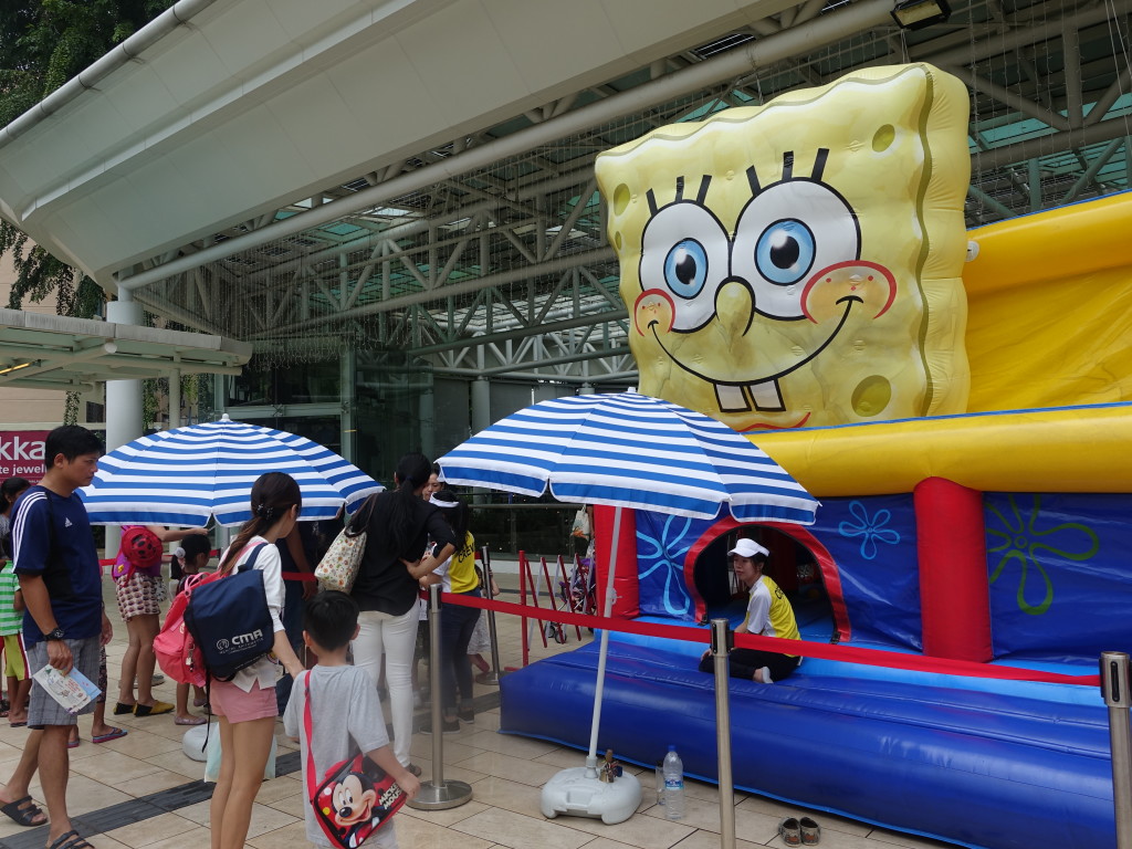Families queue up at the gigantic Spongebob bouncy castle.