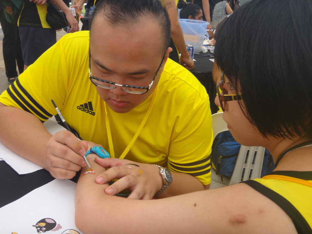 Tattoo artist in action at the race carnival.