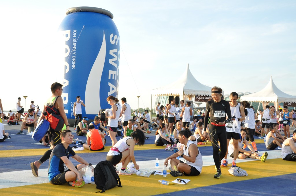 Relaxing at the race village with the large Pocari Sweat can as a backdrop.
