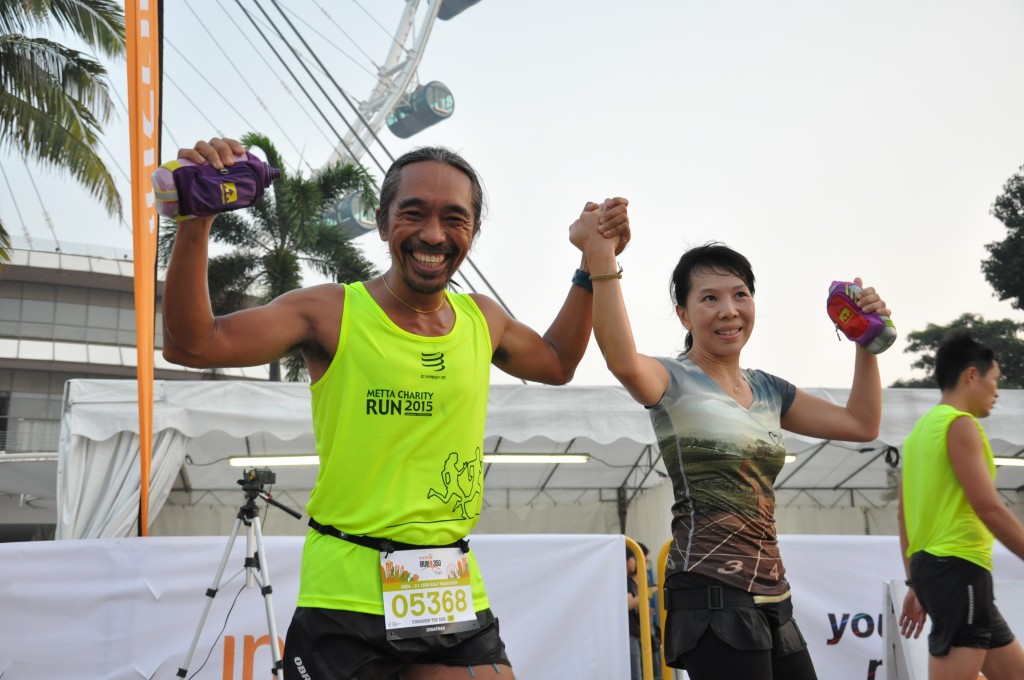 Runners hold hands as they cross the finishing line.