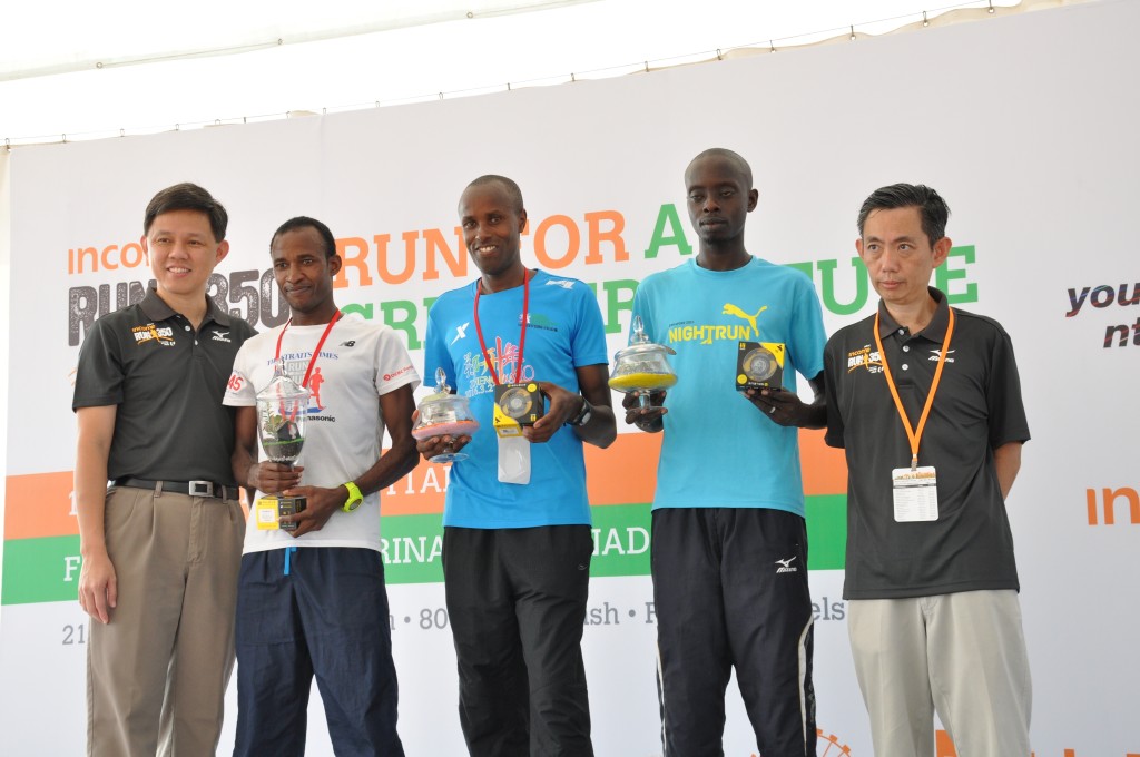 Winners pose with their unique "green" trophies - plants sealed in glass containers.