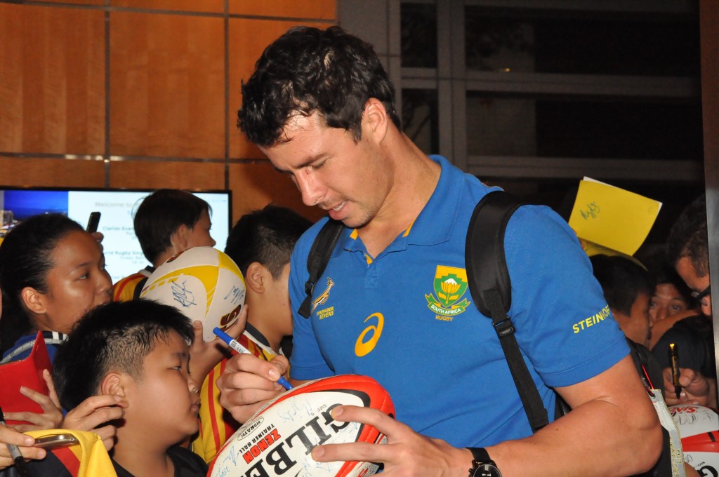 An eager young rugby fan gets his ball signed.