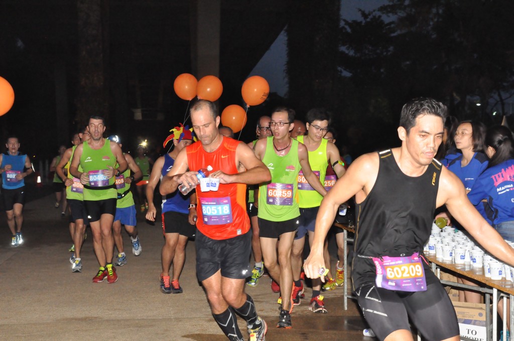 A runner grabs hydration before continuing with his race.