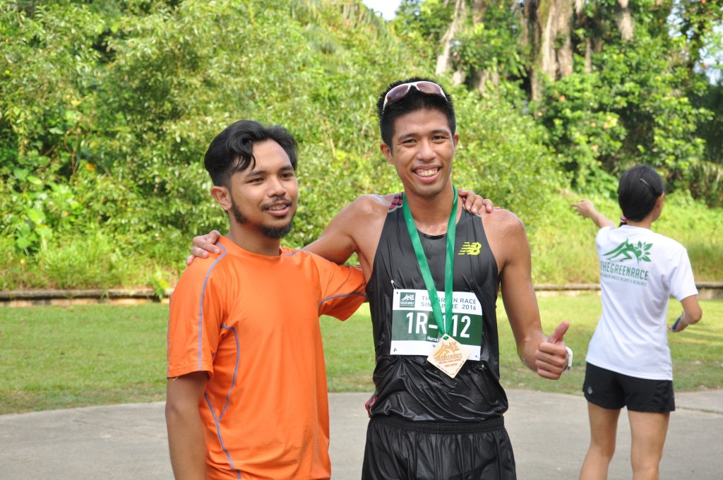 A runner wears the race medal around his neck.