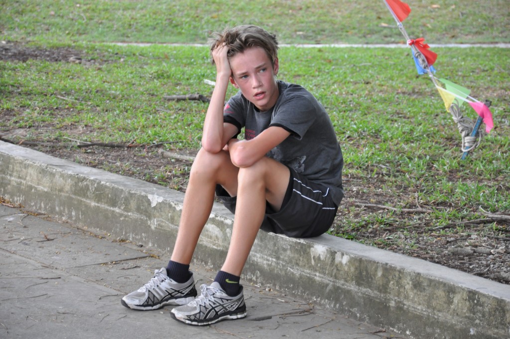 A young runner cools down and catches his breath.