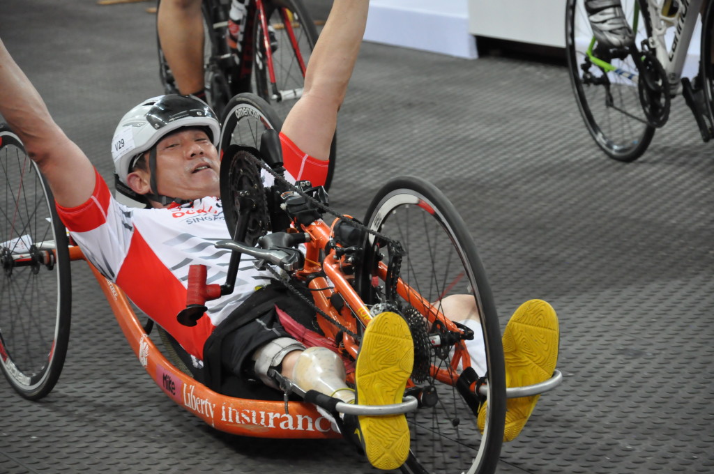 The hand cyclist is happy to cross the finish line!