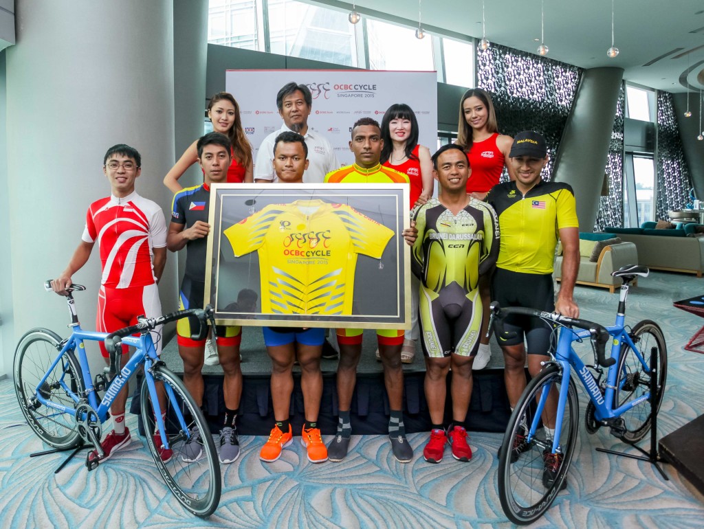  Team Singapore Cyclist, Low Ji Wen (extreme left), along with Team Captains Jerry Jr. Aquino from Philippines (second from bottom left), Yoeun Phyuth from Cambodia (third from bottom left), Jeevan Manjula Jayasinge Silva from Sri Lanka (third from bottom right), Reduan Bin Yusop from Brunei (second from bottom right), Muhammad Fauzan Bin Ahmad Lutfi from Malaysia (extreme bottom) right, Mr Suhaimi Haji Said, President of Singapore Cycling Federation (second from top left), Ms Koh Ching Ching, Head of Group Corporate Communications OCBC Bank (second from right), and the two OCBC Sportive girls pose for a group photo at the official OCBC Cycle 2015 press conference that was held at Hotel Jen, Orchardgateway Singapore on Friday afternoon. (Photo Credit: OCBC Cycle 2015)