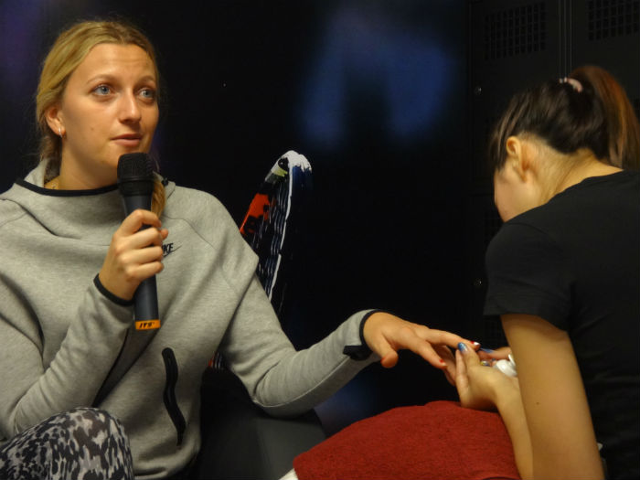Getting her nails painted.