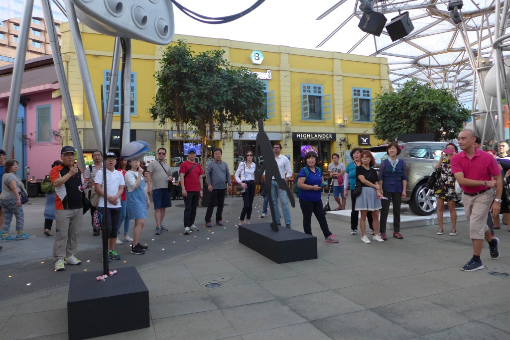 A participant tries his hand at throwing the rugby ball into a hole.