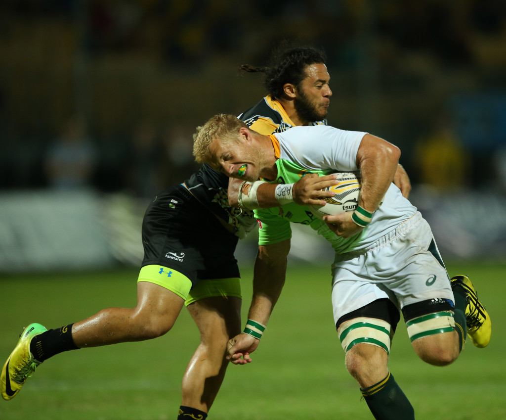 South Africa’s team Captain Kyle Brown (right) in a bid to avoid a tackle from a player from Penguins. (Photo Credit: Singapore Cricket Club)