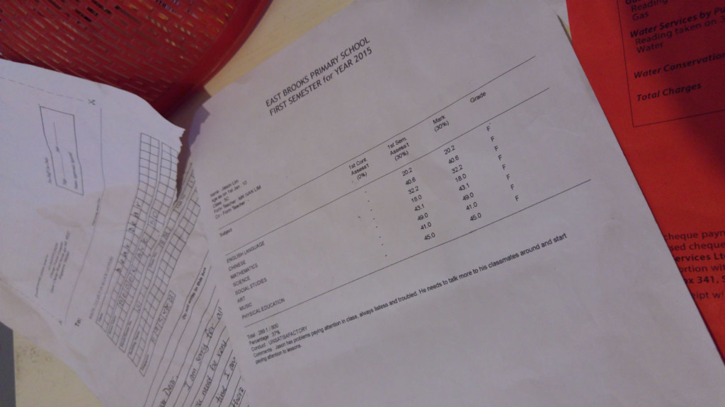 A table with unpaid bills and report cards.