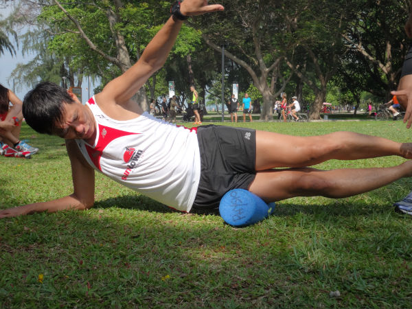 A volunteer is demonstrating how to use the foam roller.